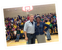 Mark Hoog and teacher in gym with students